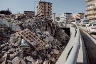A city scene showing extensive earthquake damage with debris and ruins.