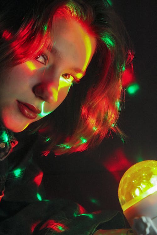 Woman Face Illuminated with Colorful Lights 