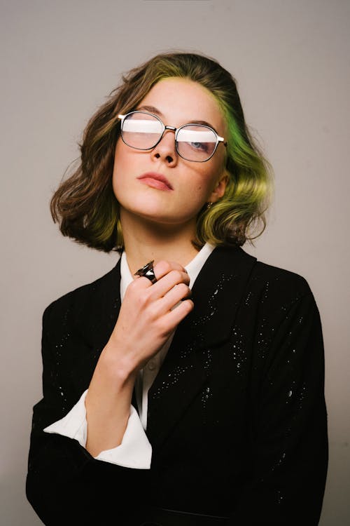 Elegant Woman in Jacket and White Shirt in Studio