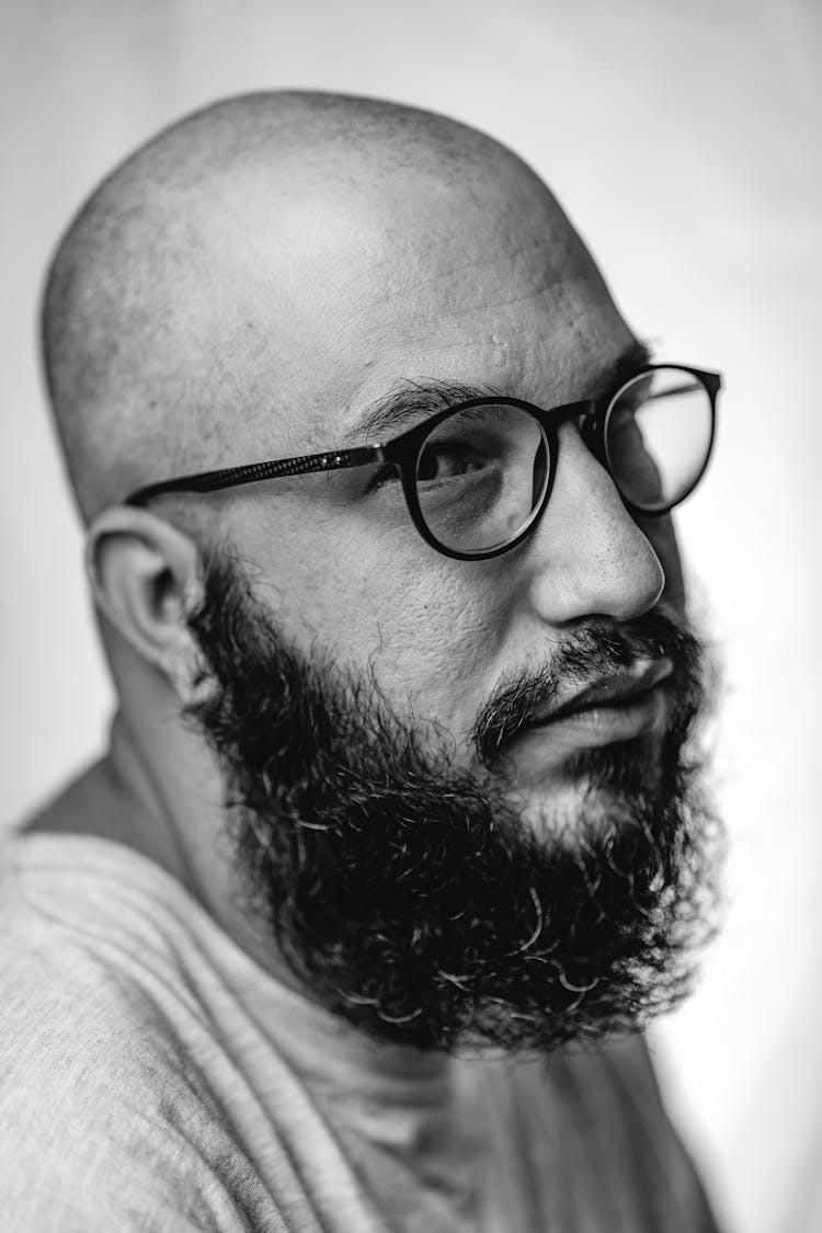 Black And White Portrait Of A Bald Man With A Beard And Eyeglasses 