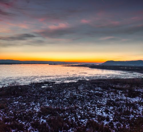 Free Captivating winter sunset view of a frozen lake in Weaver, MN, USA, with vibrant colors. Stock Photo