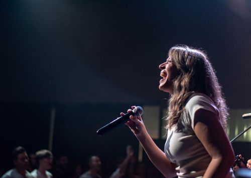 Singer performing on a lit stage during a live show — Franco Monsalvo on Pexels
