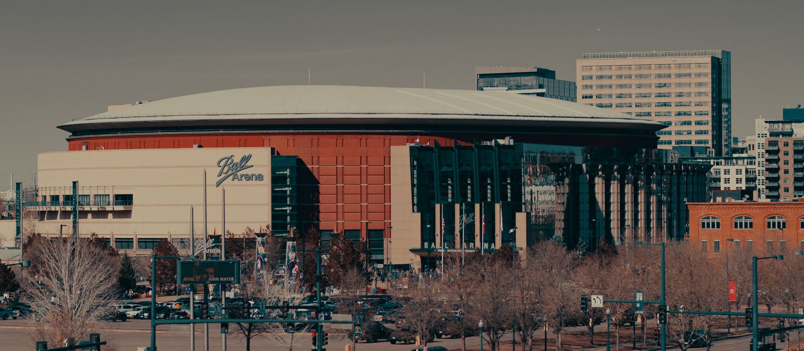 A daylight view of Ball Arena amidst Denver's urban landscape, highlighting its architectural design. — flights from Seattle to Denver