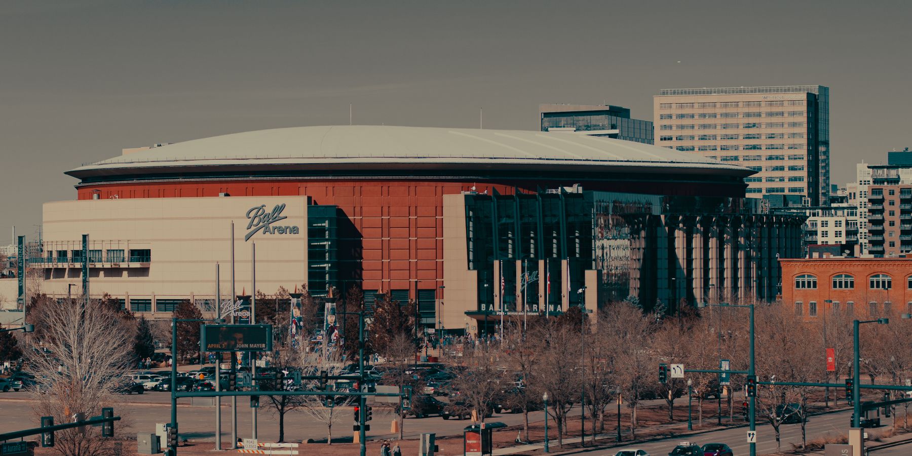 A daylight view of Ball Arena amidst Denver's urban landscape, highlighting its architectural design.