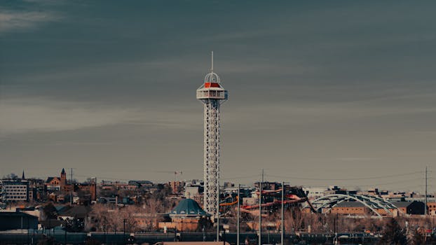 Dramatic view of a distinctive urban tower against a moody sky.