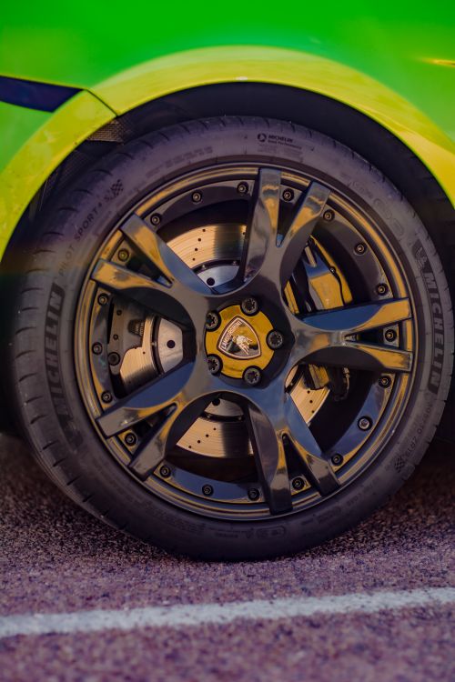 Free Detailed macro shot of a luxury car wheel showcasing the intricate design and metallic rim. Stock Photo