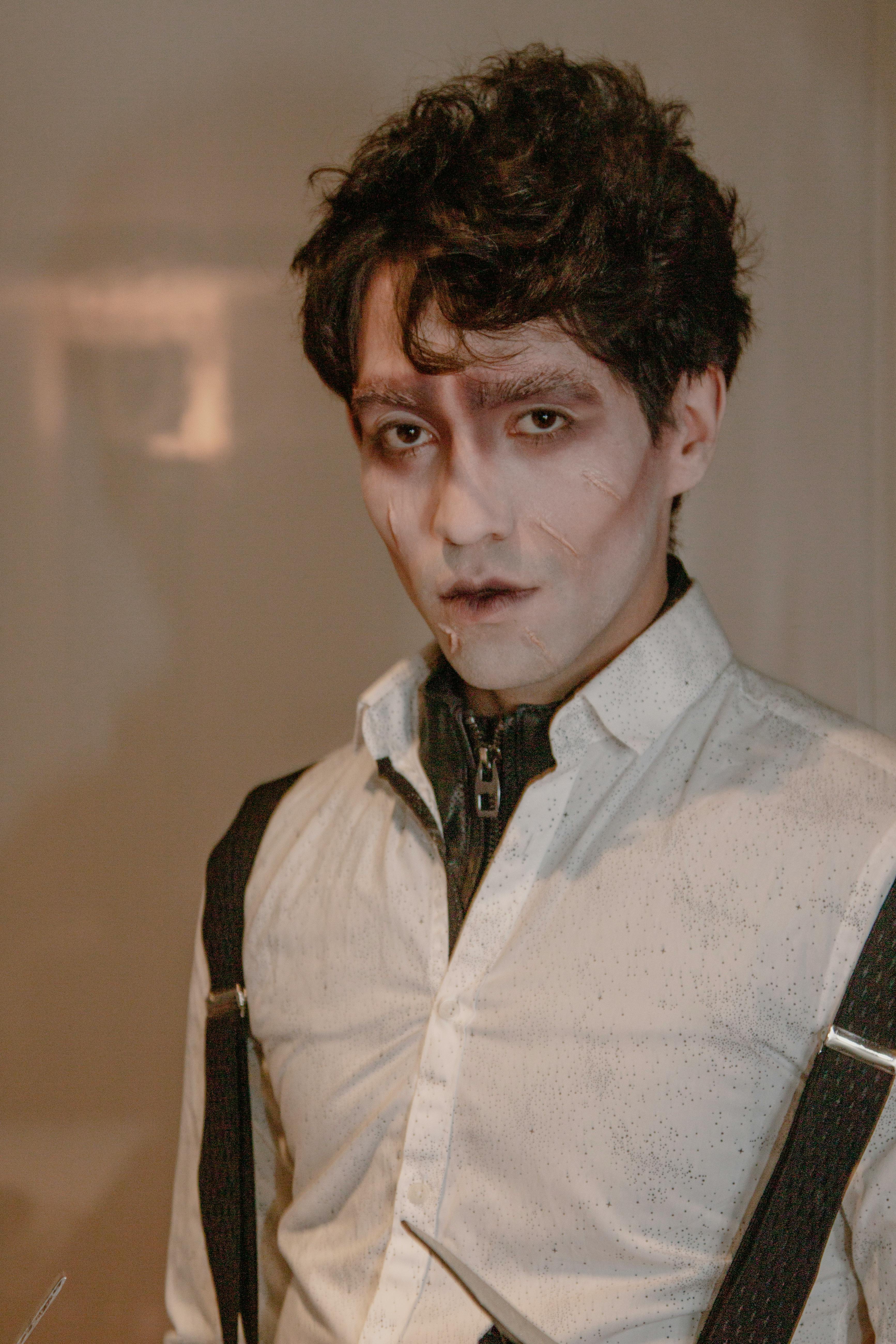 A spooky portrait of a man dressed as a zombie, perfect for Halloween themes.