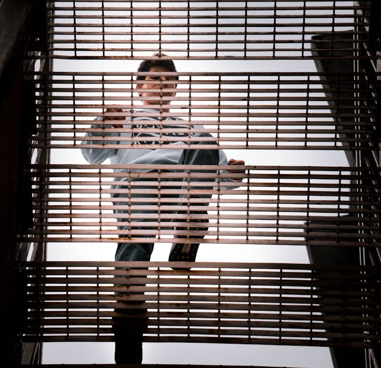 Directly Below Shot Of A Man Walking Up The Stairs 