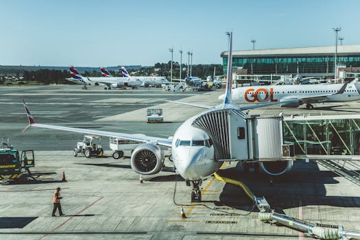 Airplanes parked at an airport apron, showcasing the busy atmosphere of modern aviation.