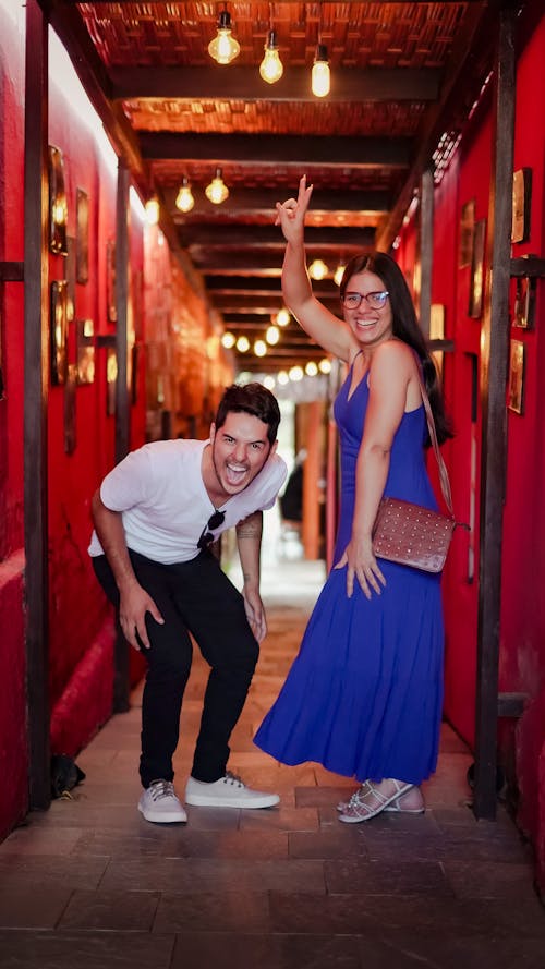 Young Couple Laughing in an Illuminated Corridor