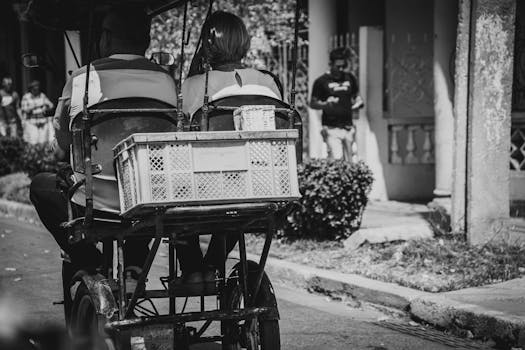 People Travelling by Rickshaw in a City