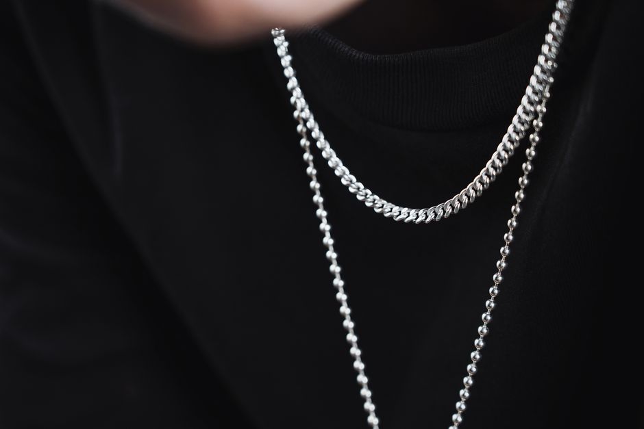 Layered men's necklaces with silver chains and symbolic pendants Layered men's necklaces with silver chains and symbolic pendants