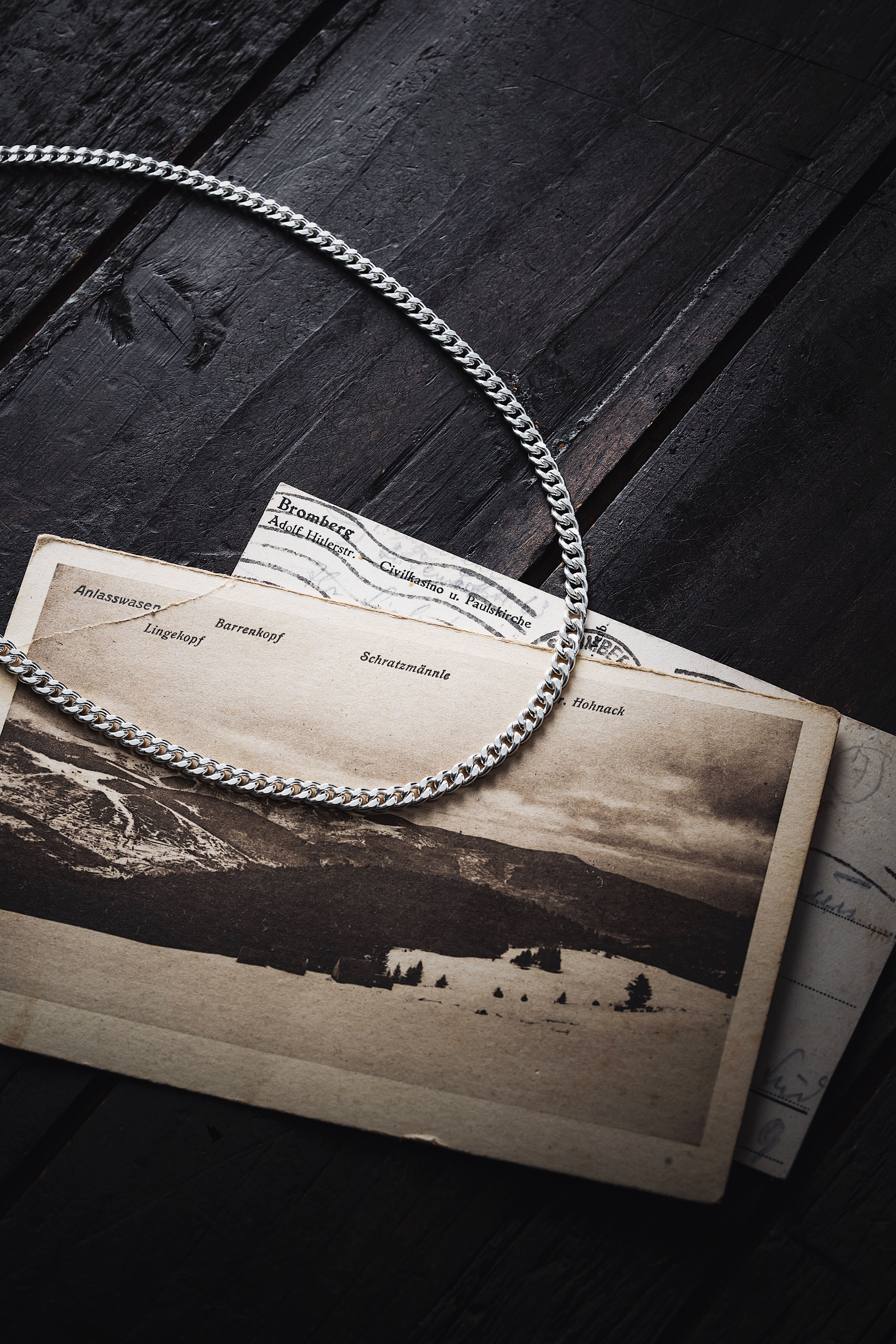 Letters and Silver Chain on Wood · Free Stock Photo