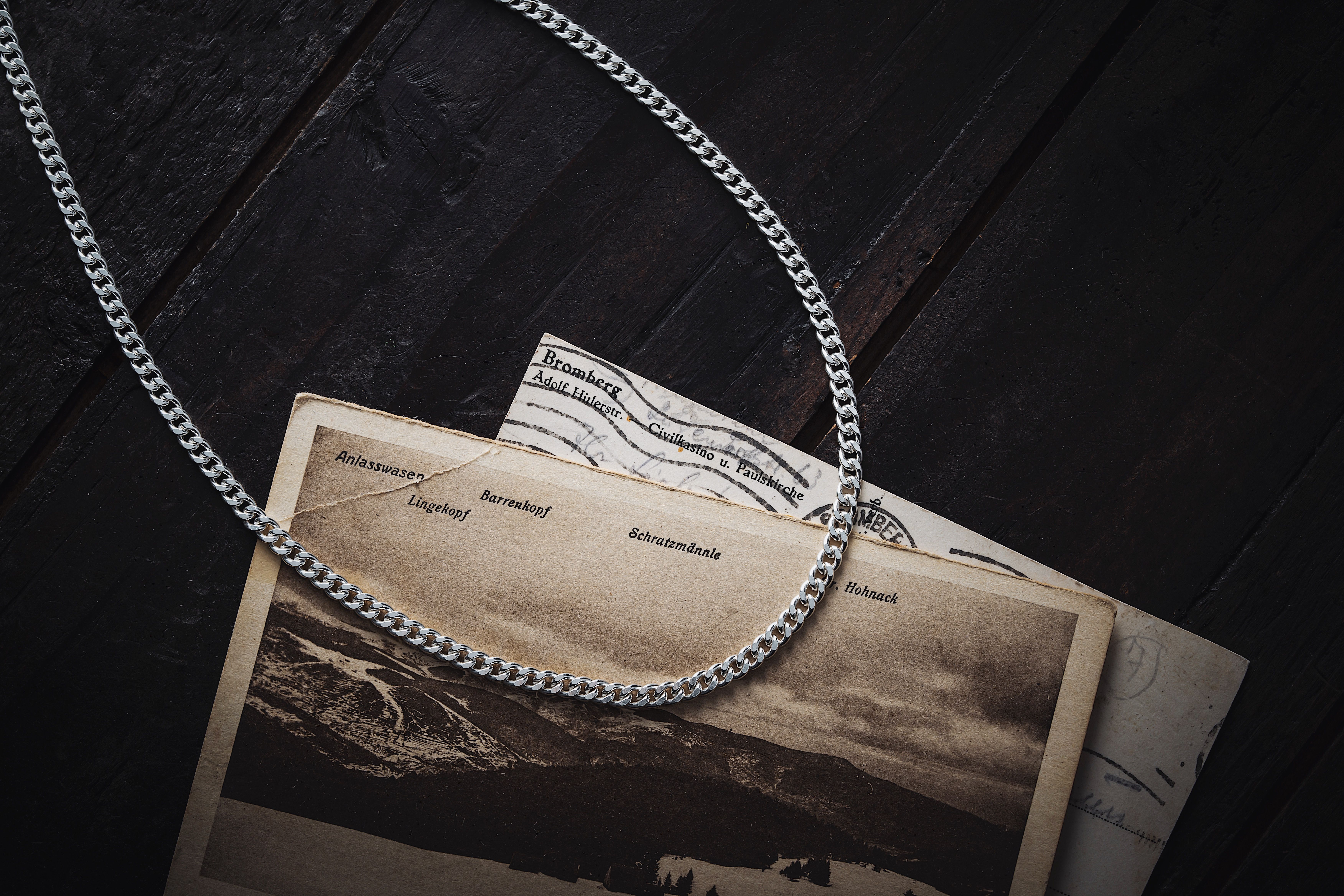 Flat lay of necklaces arranged by chain length from 14 to 24 inches on clean white surface