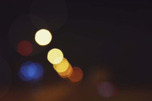 Captivating bokeh effect of colorful lights against a dark night background.
