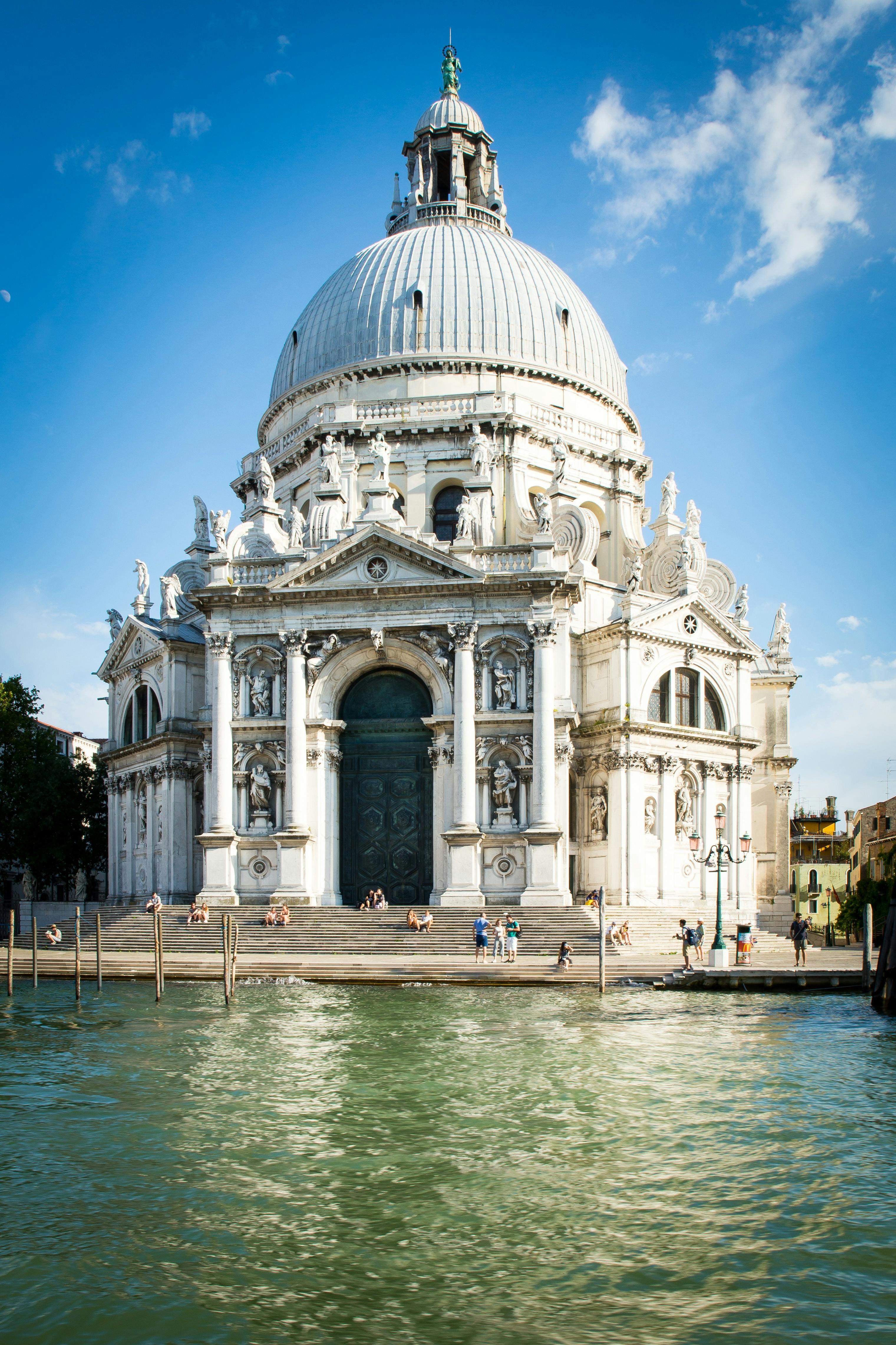 white architectural structure beside bodies of water during daytime