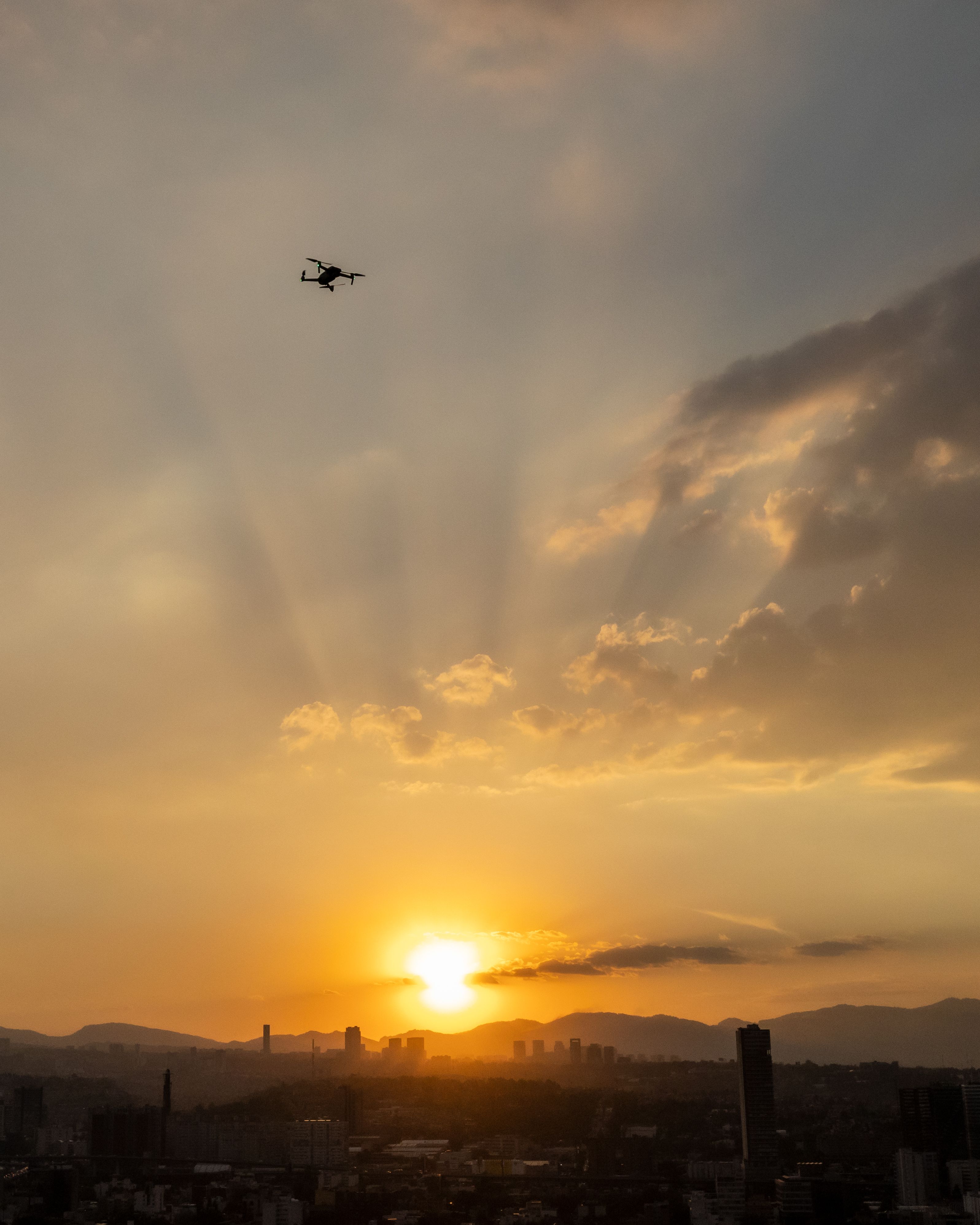 Drone flying at sunset over Mexico, illustrating the rules for flying a drone in Mexico