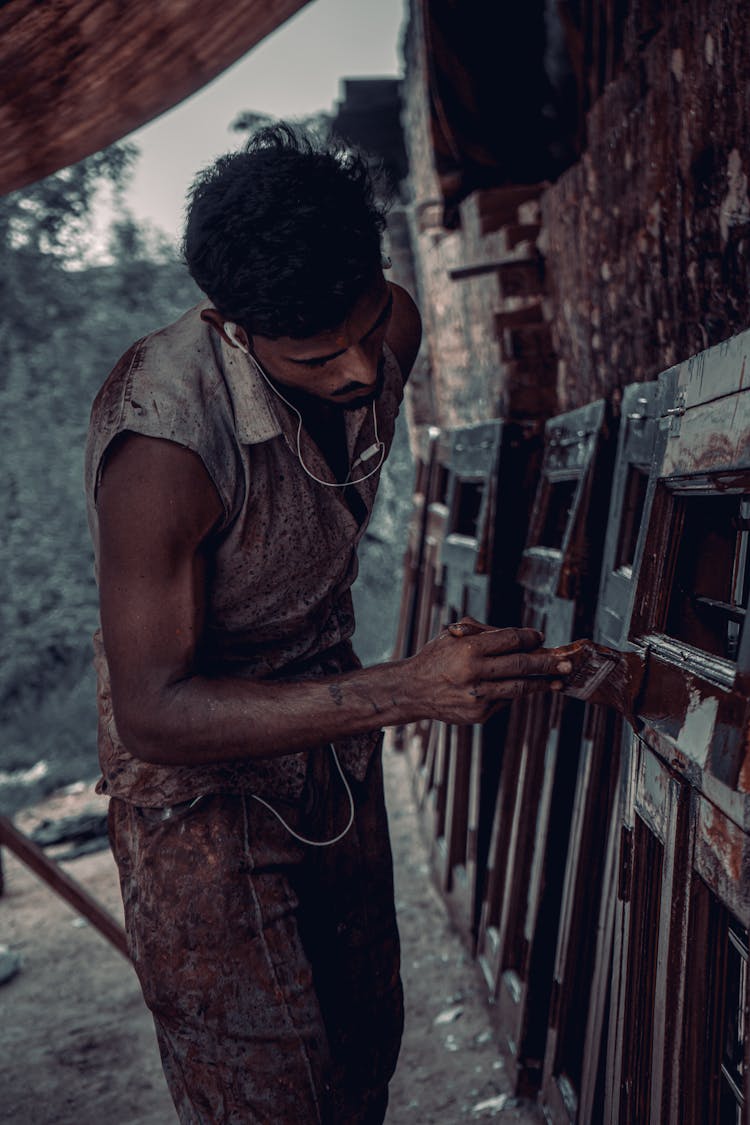 Man Painting A Fence