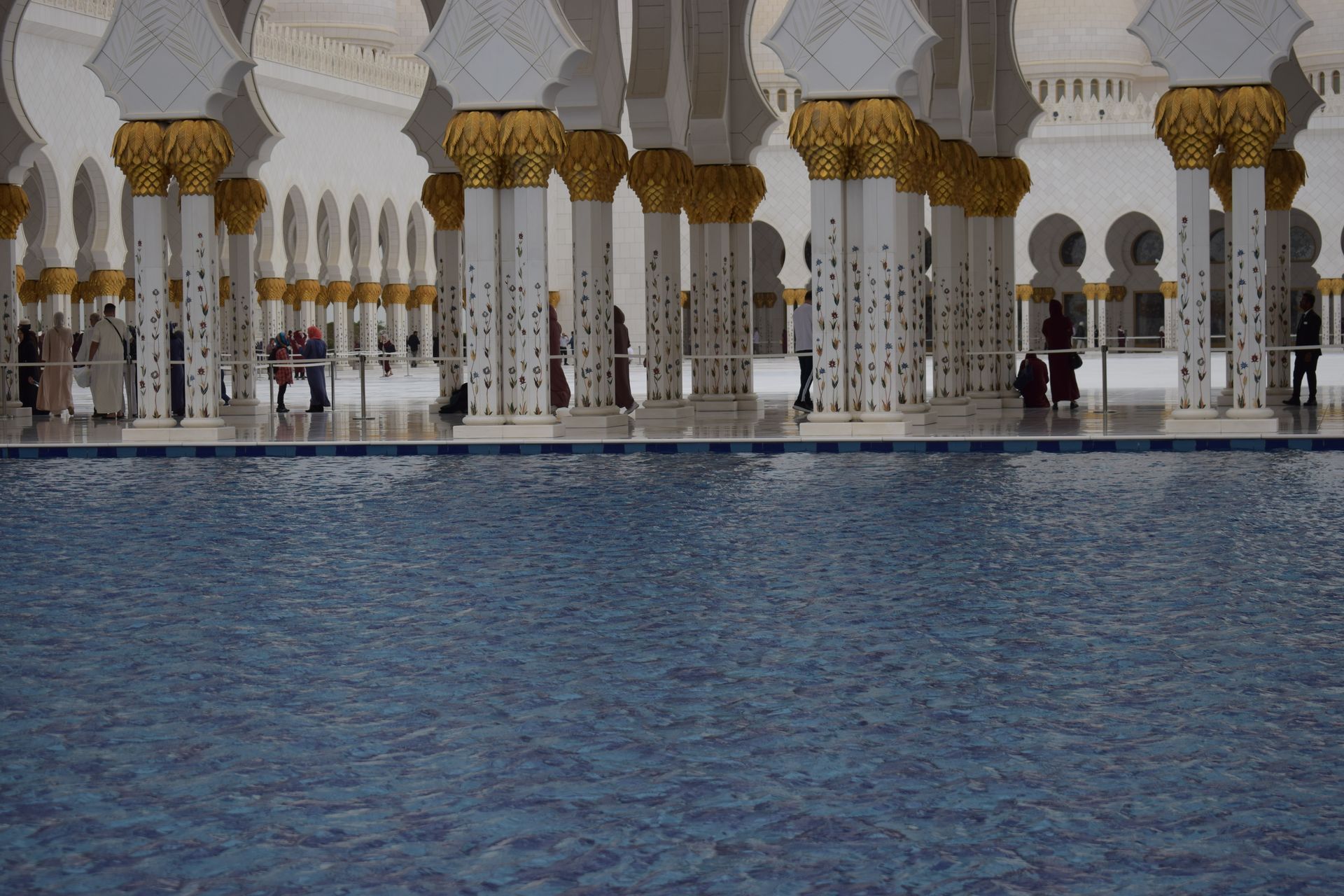 Serene view of the inner courtyard with reflections at Sheikh Zayed Grand Mosque, Abu Dhabi.
