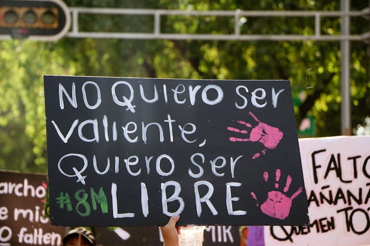 Hand Of A Protestor Holding A Banner