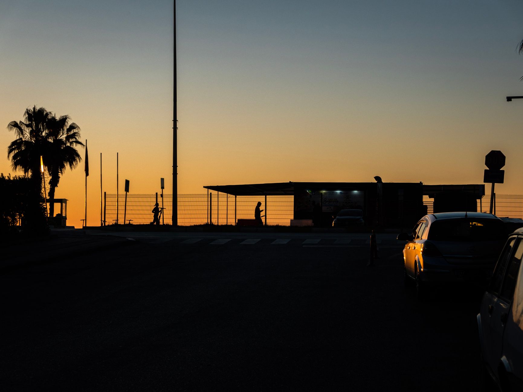 Cyclists setting off from a Cyprus hotel car park at sunrise with mountains behind