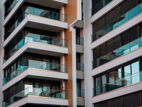 Contemporary architecture showcasing glass balconies and sleek design.