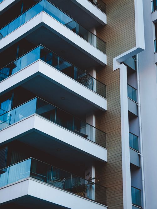 Free Close-up of a modern residential skyscraper with sleek balconies, showcasing urban architecture. Stock Photo