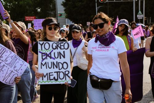 Free A vibrant women's rights protest with a diverse crowd holding banners and signs outdoors. Stock Photo