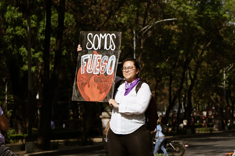 Woman Carrying A Sign Poster