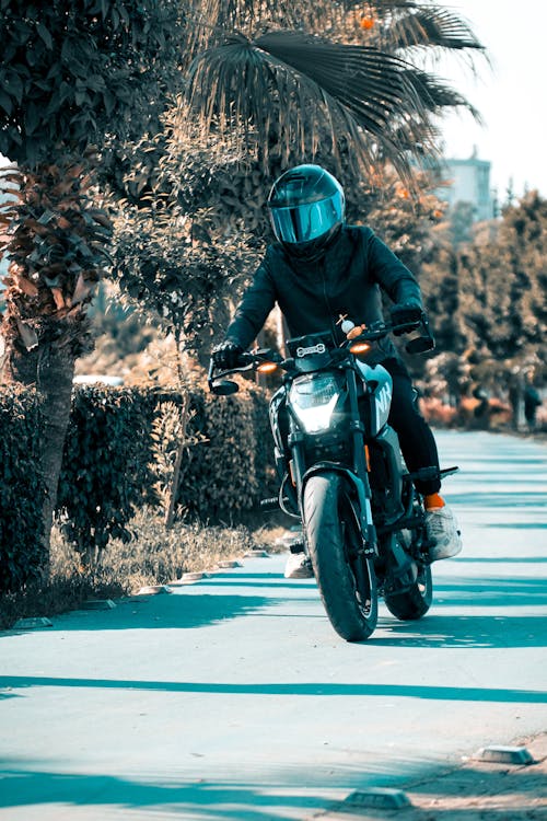 Free Man Riding a Motorcycle in a Helmet Stock Photo