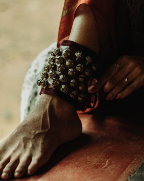 Free Close-up of a woman's foot adorned with traditional anklet bells, showcasing cultural elegance. Stock Photo