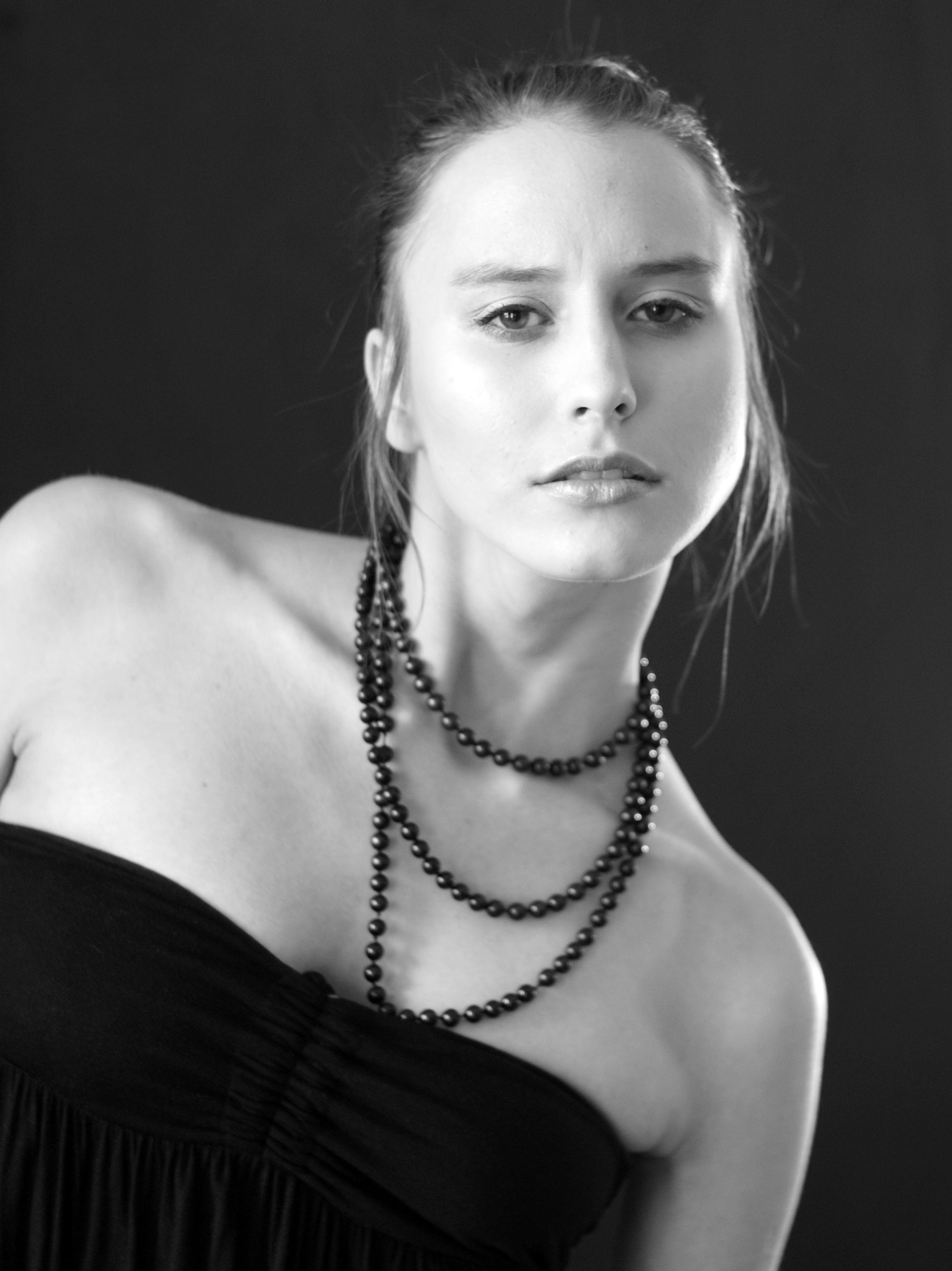 A woman in a black dress with a necklace · Free Stock Photo