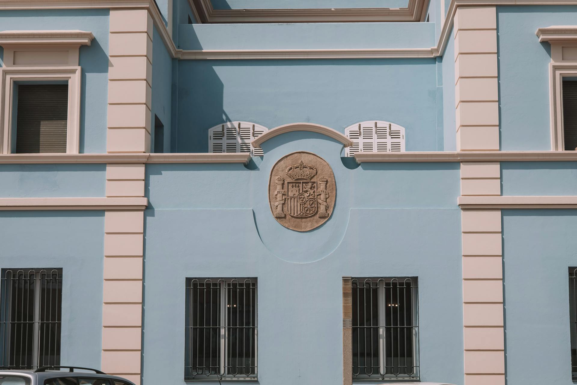 Elegant facade of a government building featuring a coat of arms in Castellón de la Plana, Spain.