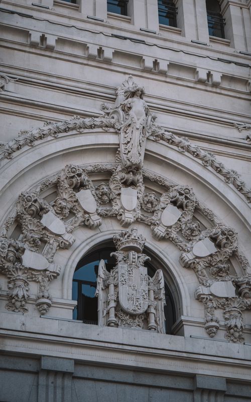 Free Ornate bas relief art on Palacio de Cibeles facade, a landmark in Madrid, Spain. Stock Photo