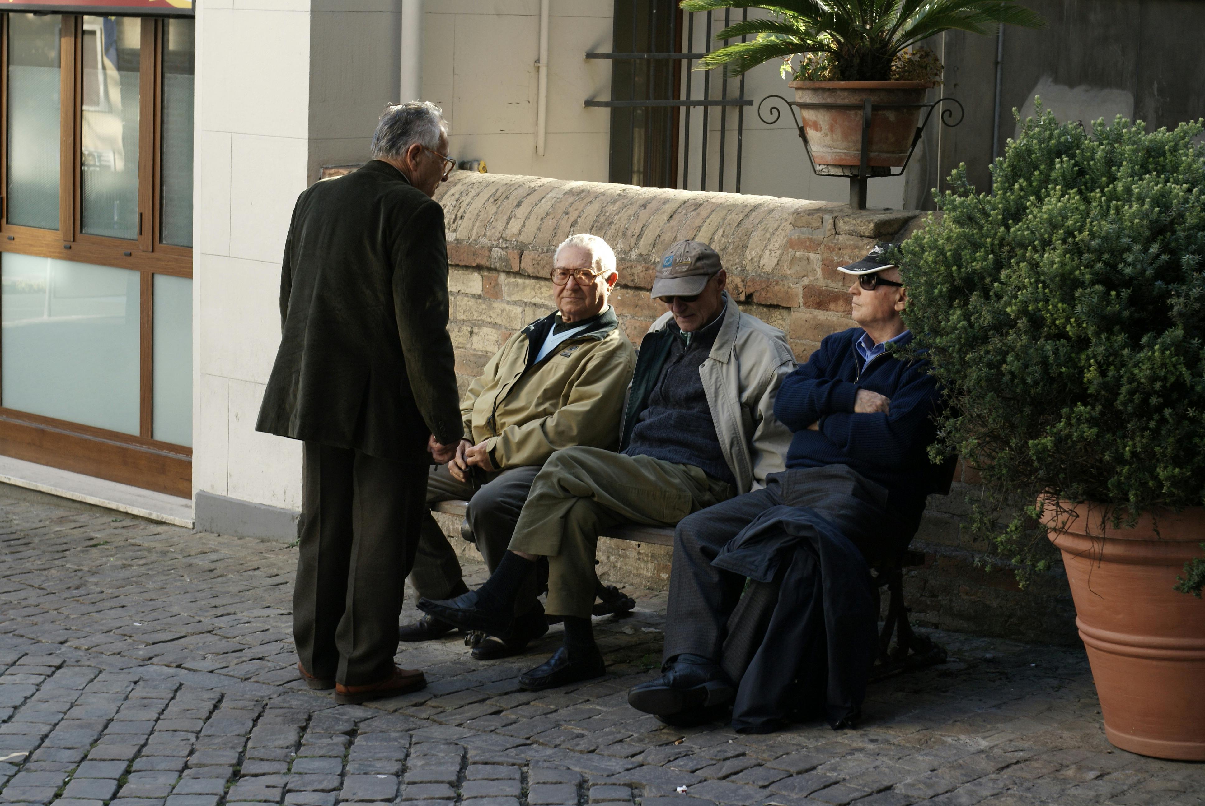 a group of men sitting on a bench