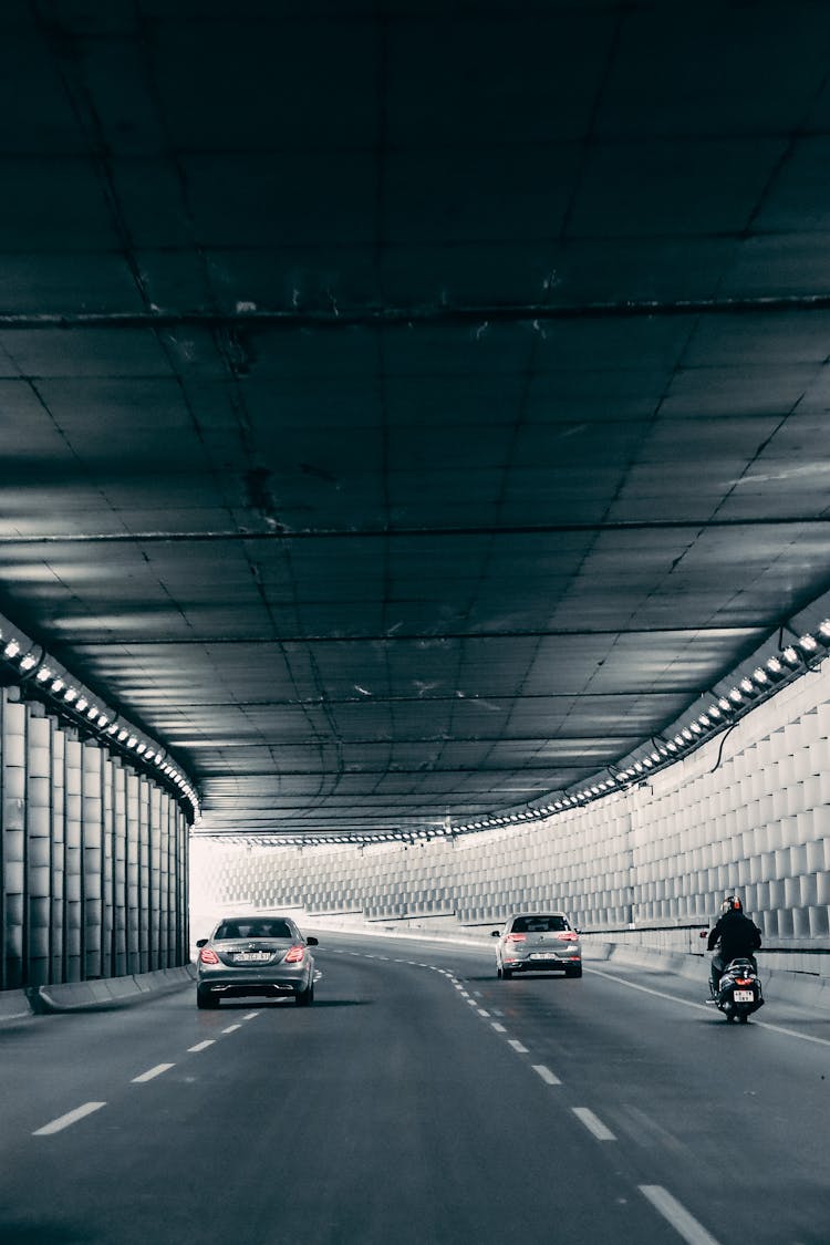 Cars Driving On Road In Tunnel