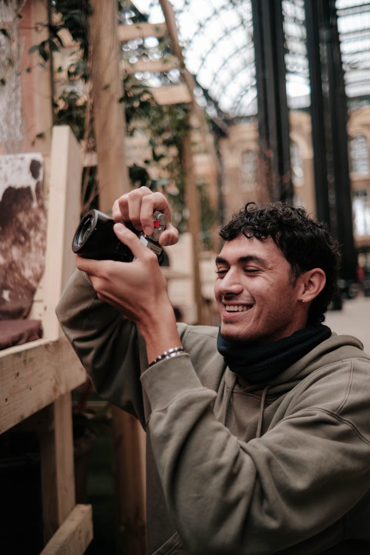 Smiling Man Taking A Photo