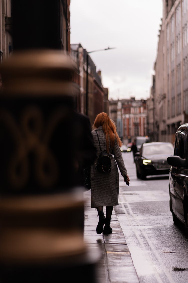 Woman Walking Near Street In Town