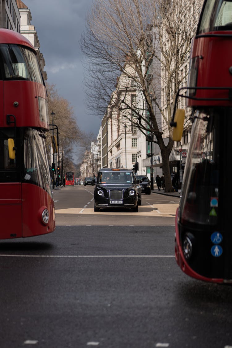 Vintage Car And Double-Decker Buses In London Street 