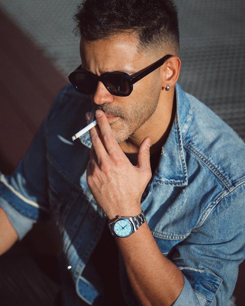 Man in Sunglasses Smoking a Cigarette
