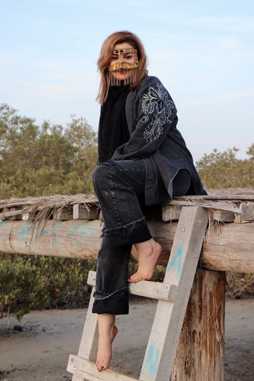 Woman Sitting on the Ladder