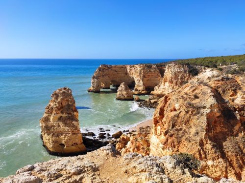 Free Breathtaking view of the Algarve cliffs and ocean in Lagoa, Portugal. Stock Photo