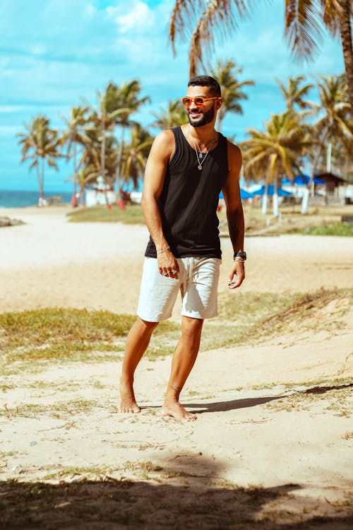 Man Walking Barefoot on the Tropical Beach 