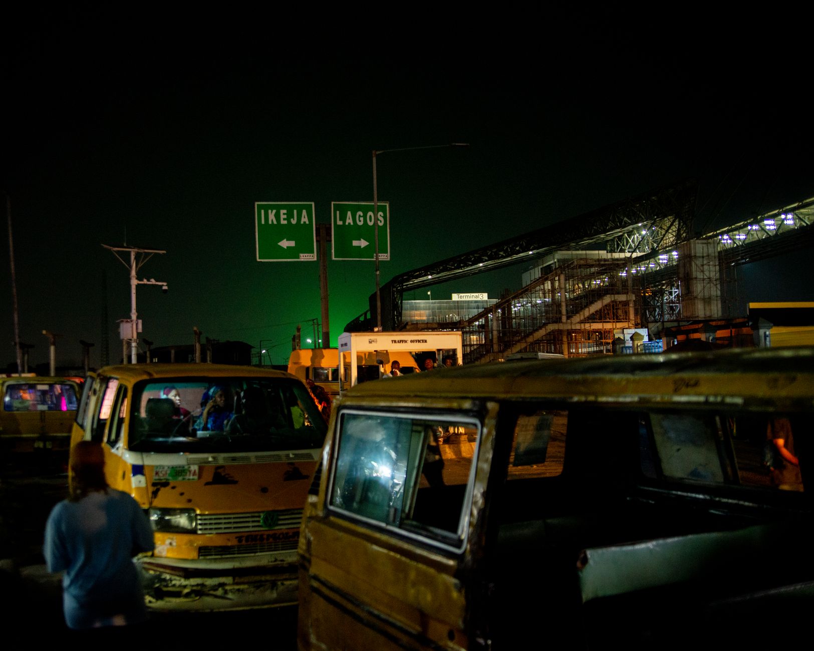 Lekki-Epe Expressway traffic at dusk with okadas and danfos
