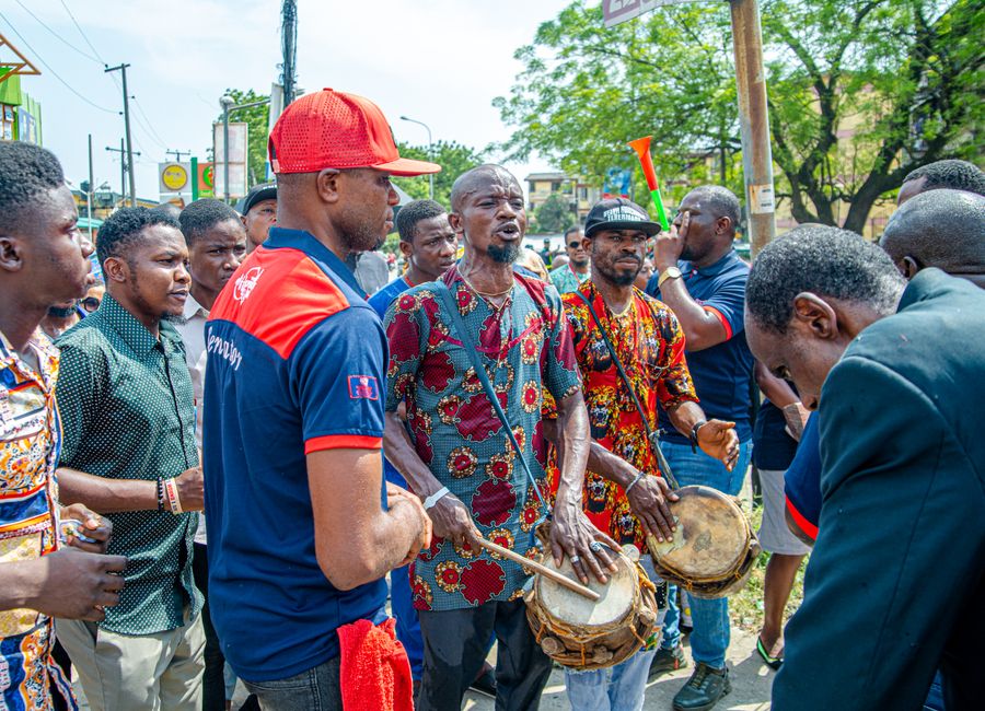 Energetic street musicians performing traditional drumming in Lagos, Nigeria.