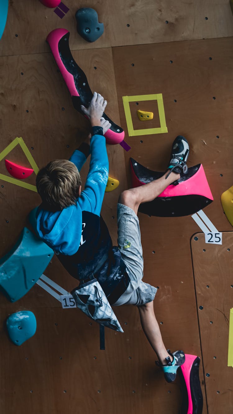 Boy Climbing On Wall