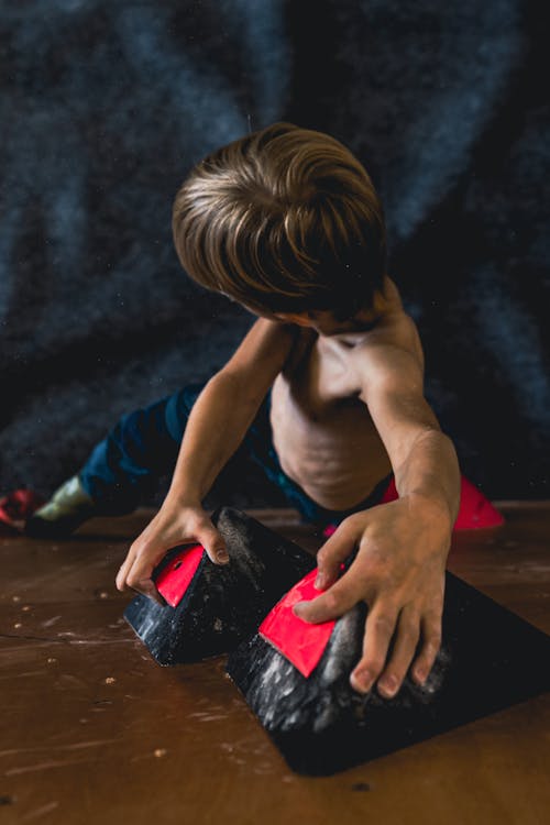 Boy Climbing on Wall Indoors