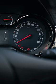 Detailed close-up of a car's speedometer, displaying speed in km/h with red needle indicators.
