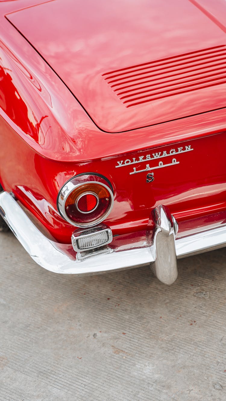 Exhaust Pipe And The Rear Light Of A Red Car