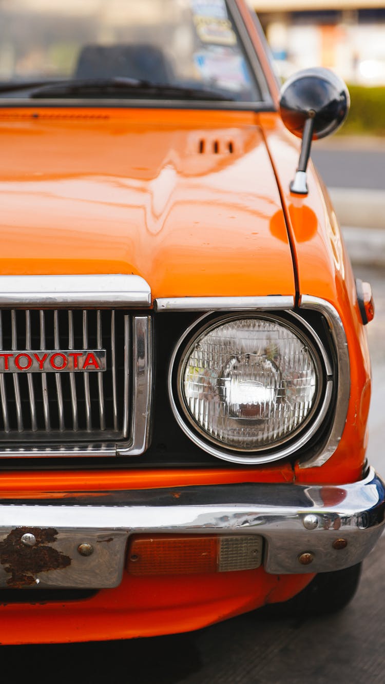 Front Of A Classic Orange Toyota Corolla E30